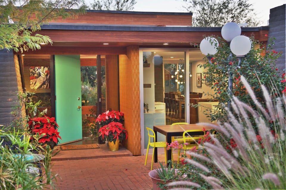 Front entrance with bubbling water feature and two sitting and dining areas