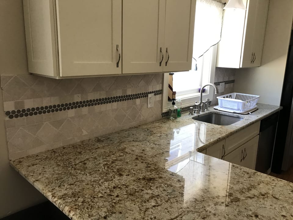 Granite island eating area and tile backsplash