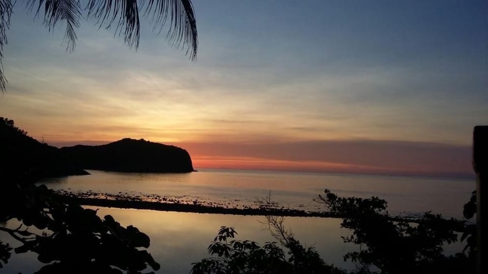 A beautiful sunset view of Haad Thong Lang Bay and Ko Ma taken from Dee Dee Villa Retreat