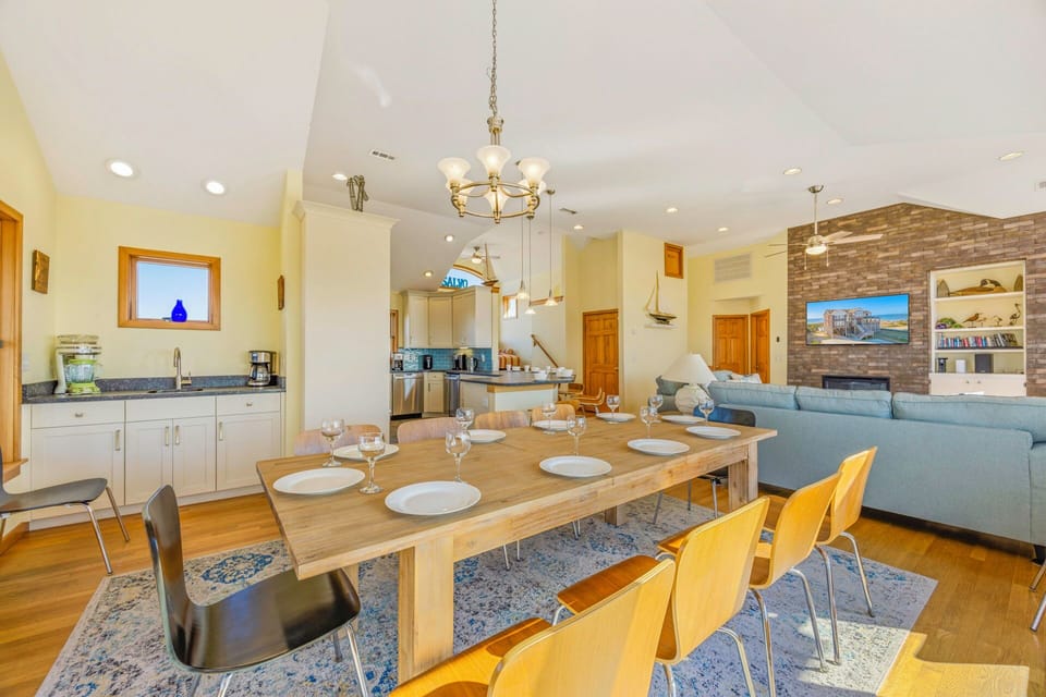 Your spacious open-plan living area features a stunning dining table for eight and cozy seating around the elegant fireplace.