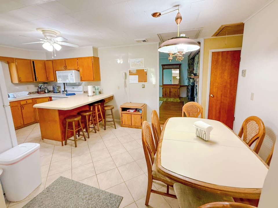 Eat-in kitchen with table and six chairs (two folding chairs make it eight).