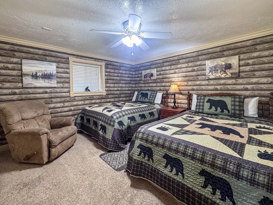 Charming woodland-themed bedroom with two cozy beds, perfect for families and group stays.