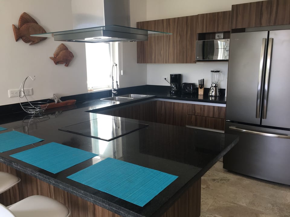 Bright & fully equipped kitchen with stainless appliances.