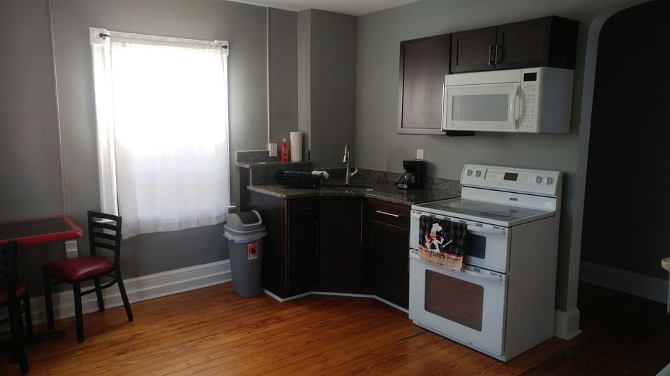 Kitchen with granite counters, double oven, new cabinets, hardwood floors
