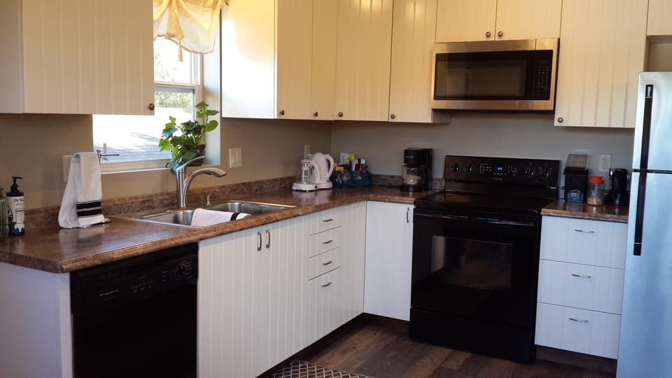Full kitchen stocked with plenty of serving, cooking, and baking needs.