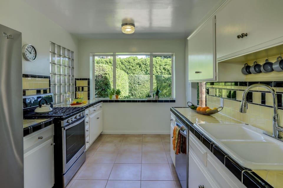 Large kitchen adjacent to dining area with new stainless steel appliances