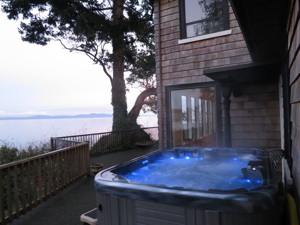 Warm Hot tub for relaxing and listening to ocean waves roll in.   Photo at dusk.