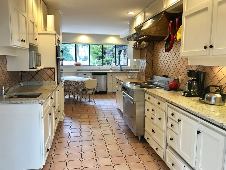 Prep area of spacious kitchen, quartz counters