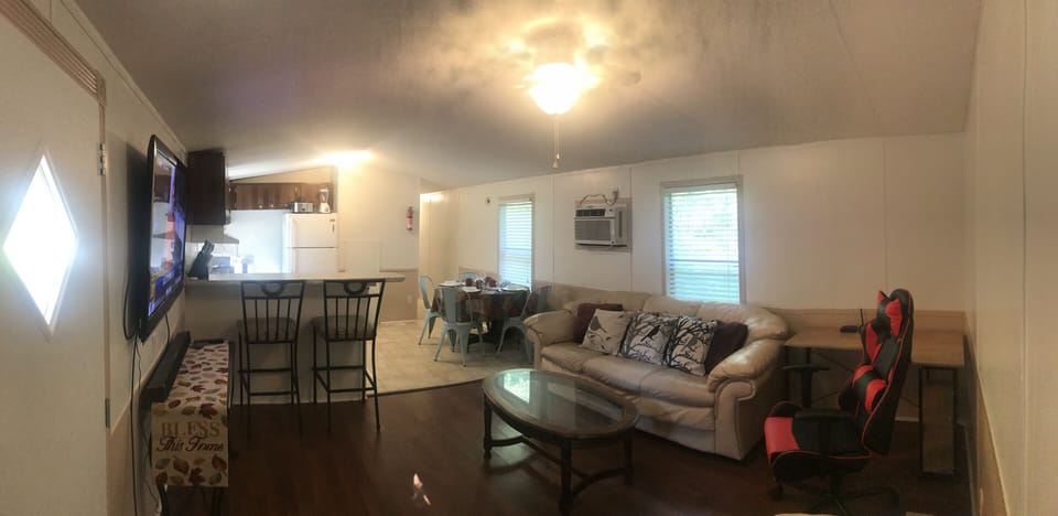 A panoramic view of Inn the Woods' kitchen and living room from the front door.