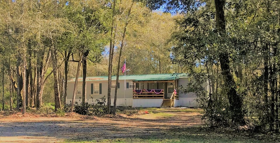 Secluded but only 2 miles from Live Oak on a paved road.