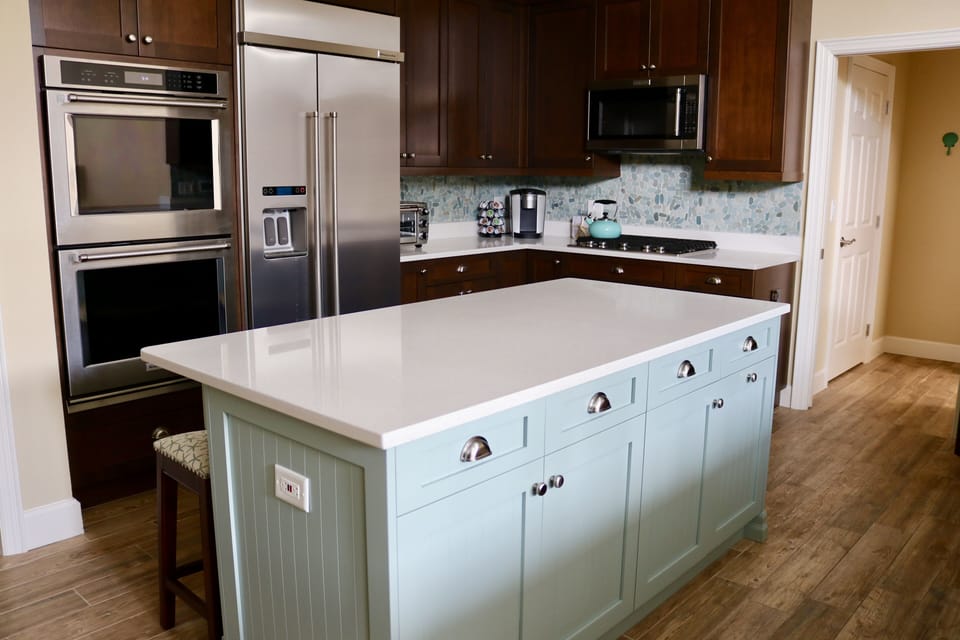 Kitchen view #2; two ovens; new refrigerator and ice maker; 3 counter chairs 