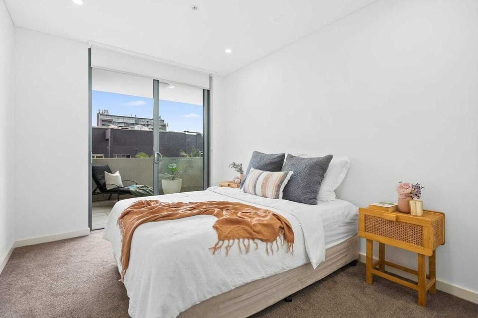 Second bedroom with balcony access, builtin robes, reverse cycle AC 