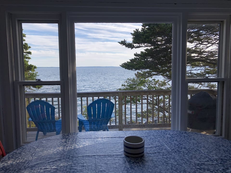 View from dining area onto deck and overlooking Blue Hill Bay
