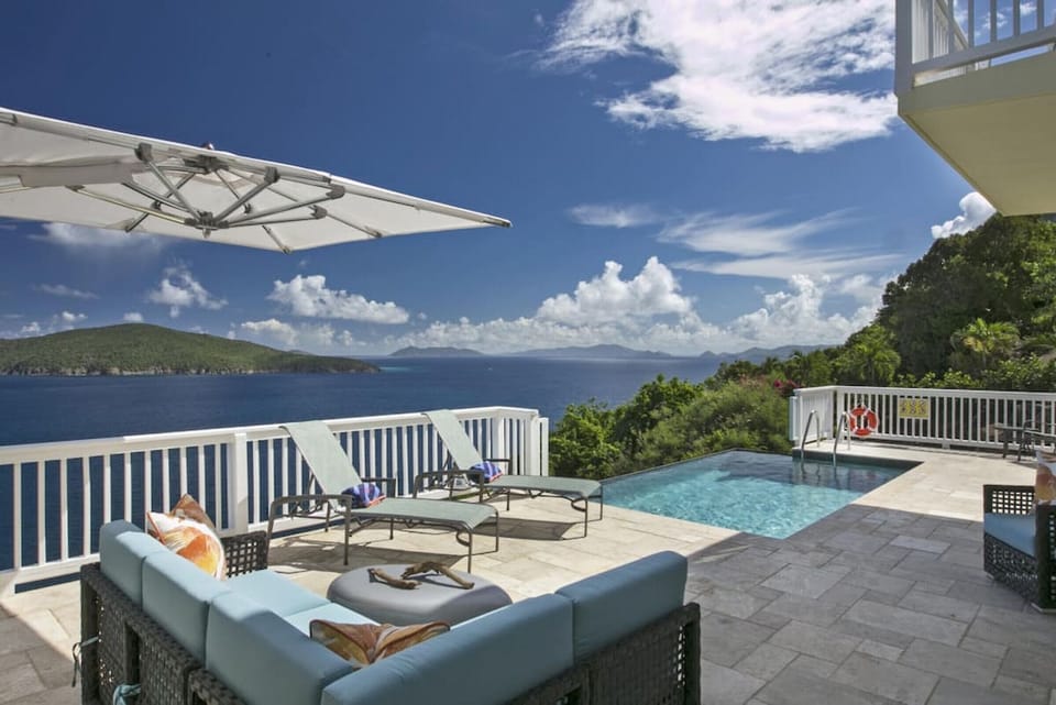 An infinity-edge pool with incredible views and comfy outdoor furniture.