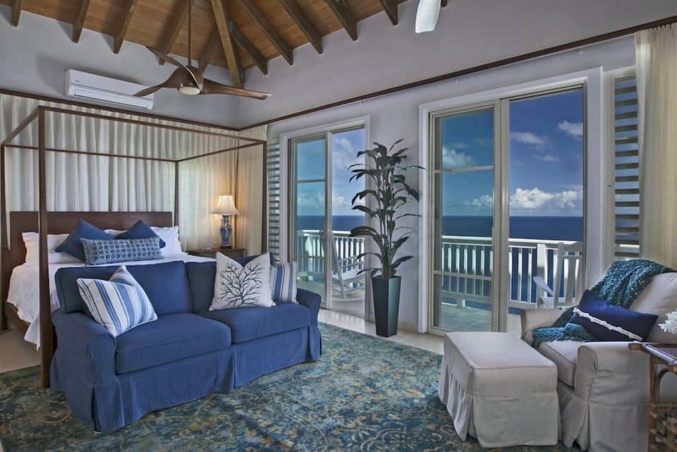 The spacious prime bedroom with king bed, AC, flat screen TV, a full sleeper sofa, private balcony, and en-suite bath!
