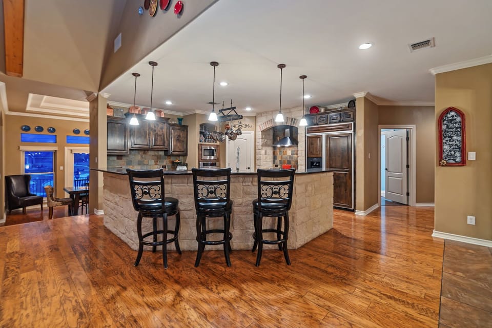 View of large kitchen island.  5 barstools available.