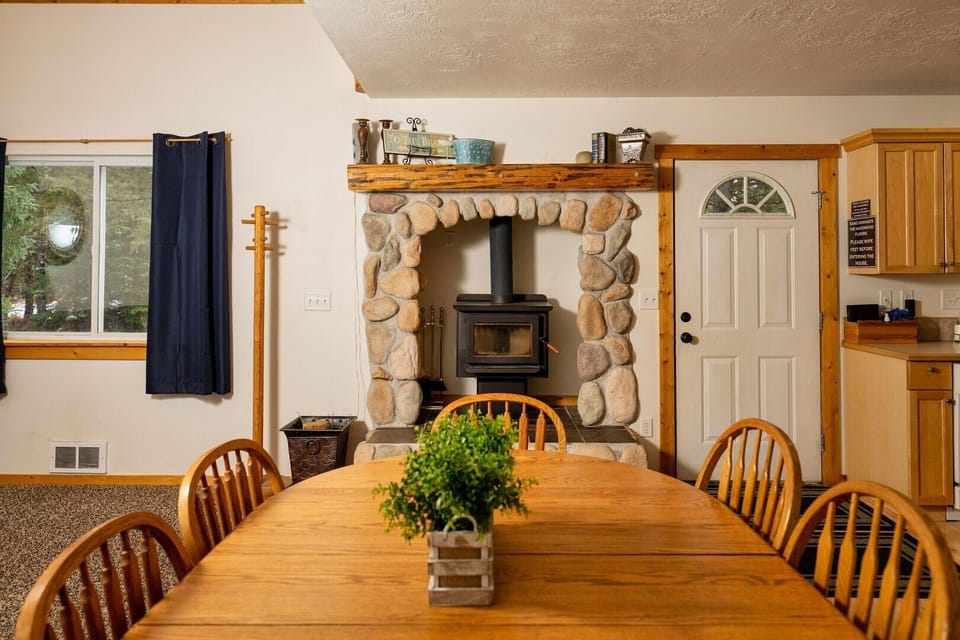 The charming dining area, which sits between the living room and kitchen, is the perfect spot for enjoying a meal or playing a game of cards.