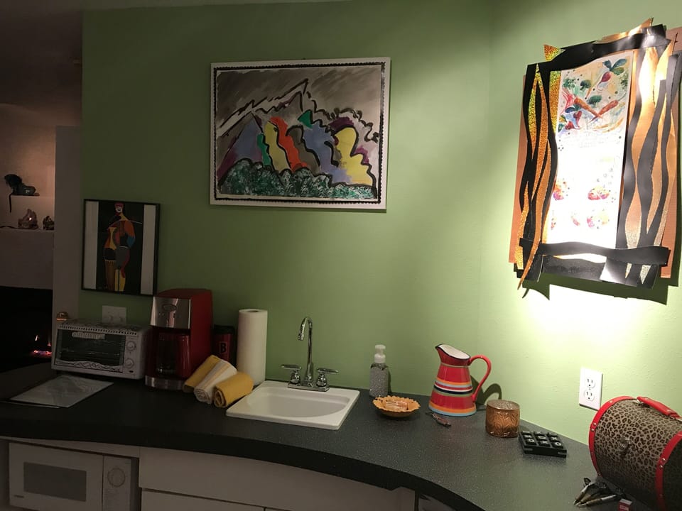 Wet Bar with small Refrigerator. Dishes and Silverware.