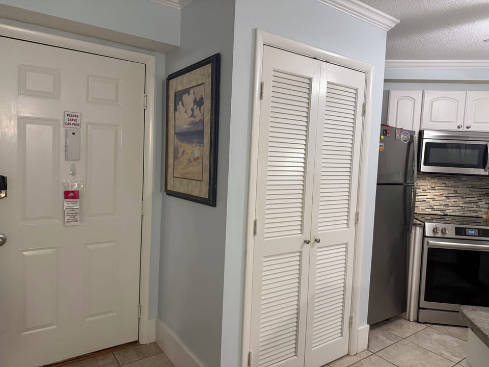 Front door, washer and dryer closet, and kitchen