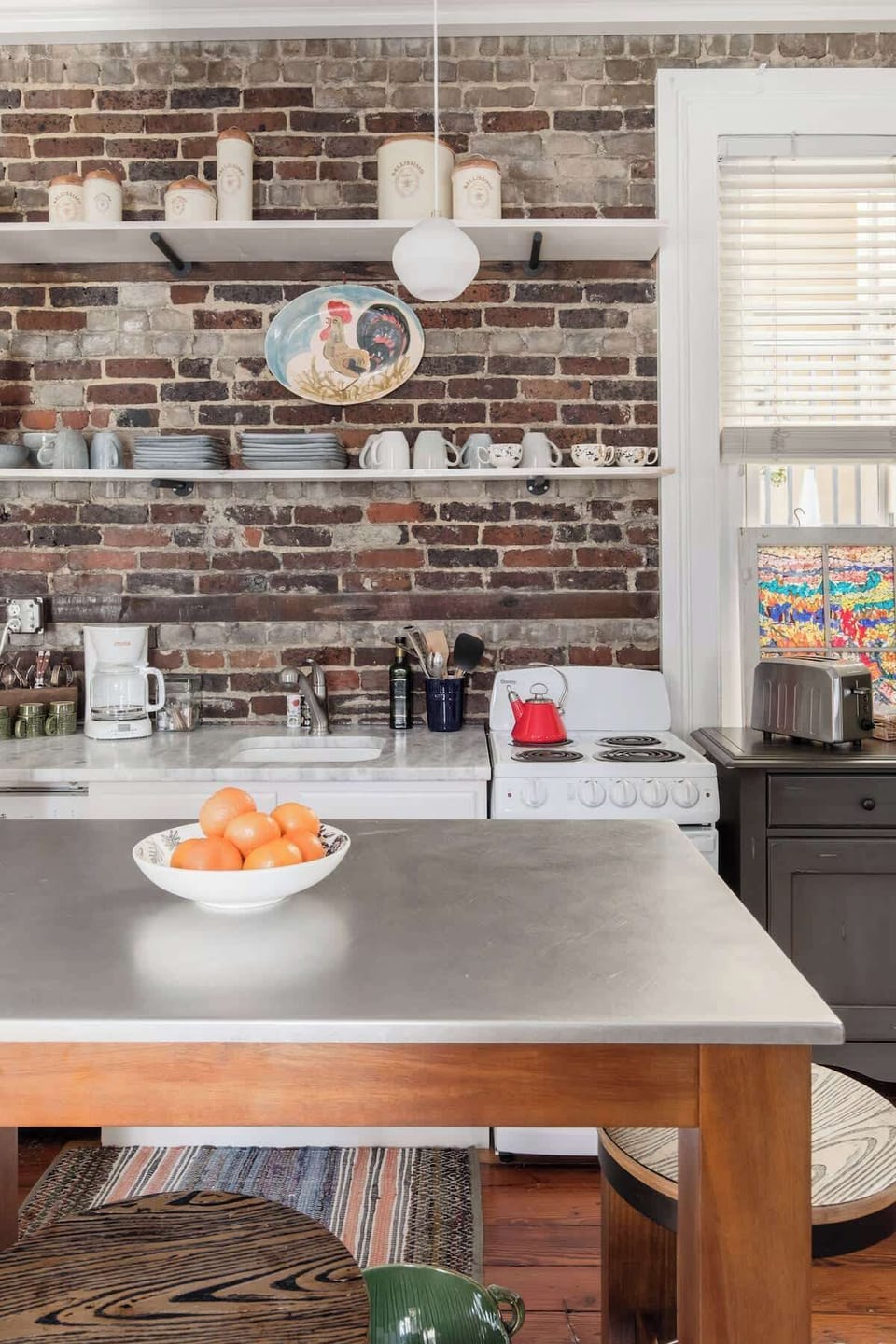 stainless top island/bar and brickwork makes this open layout  perfect for gatherings