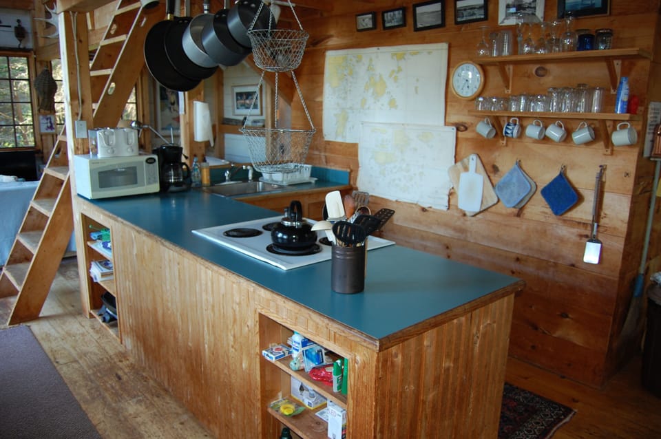 Full open kitchen with views to dining area, living room, and ocean views