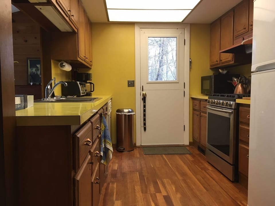 Vintage galley kitchen with chef's stove and new appliances
