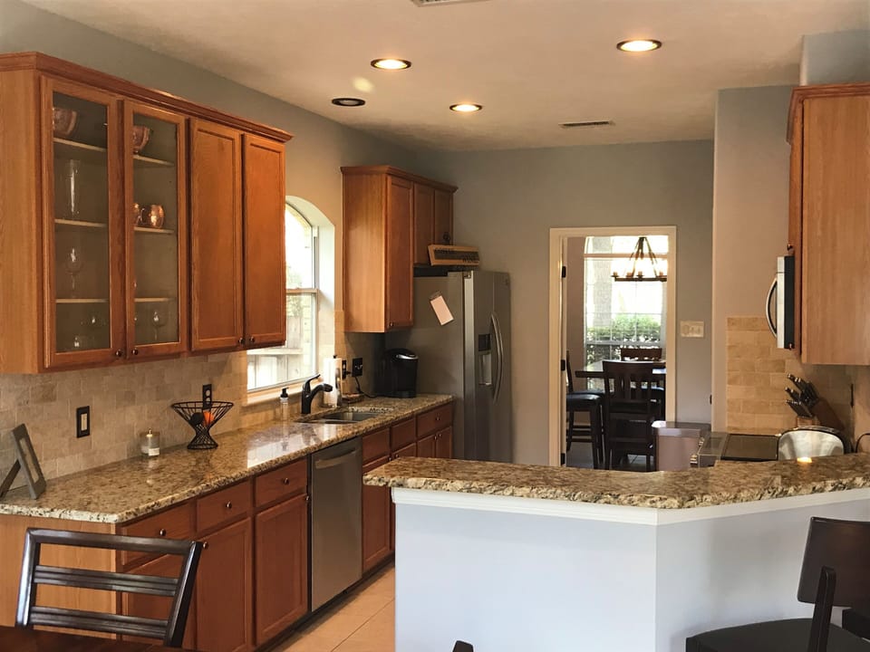Granite countertops and breakfast bar with stainless appliances