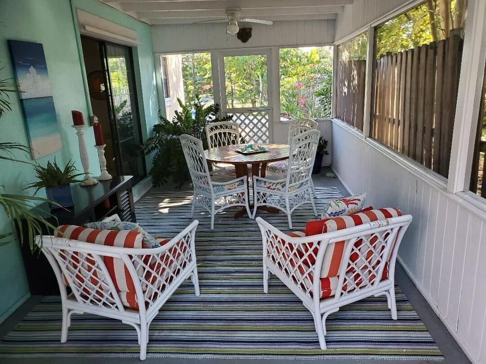 Charming fully screened sunporch or outdoor breakfast nook. Ceiling fans.