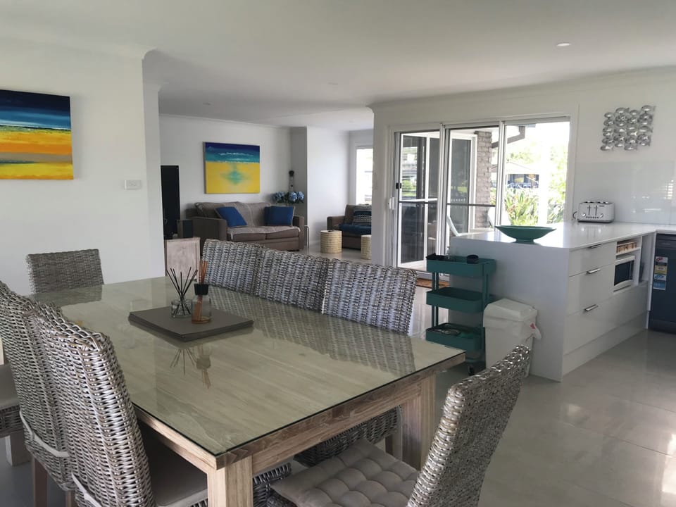 Comfortable dining and open plan areas flow to deck