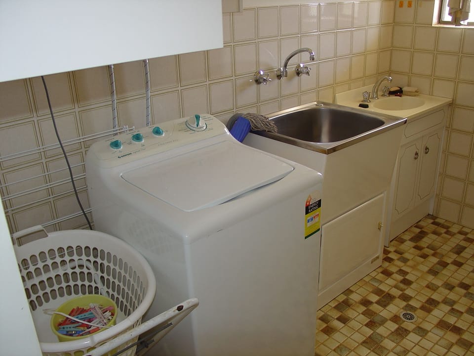 Top load washing machine. Outdoor paved hoist area or indoor airing racks.