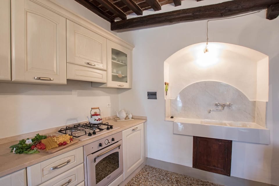 well equipped kitchen with marble sink