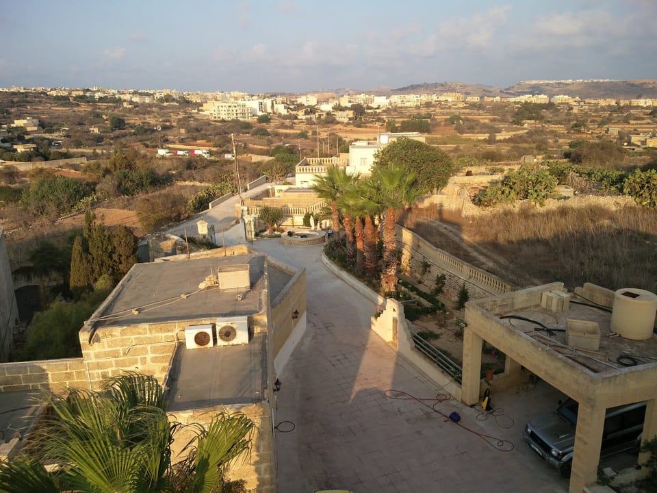 South overhead view of carport and entrance from roof . 