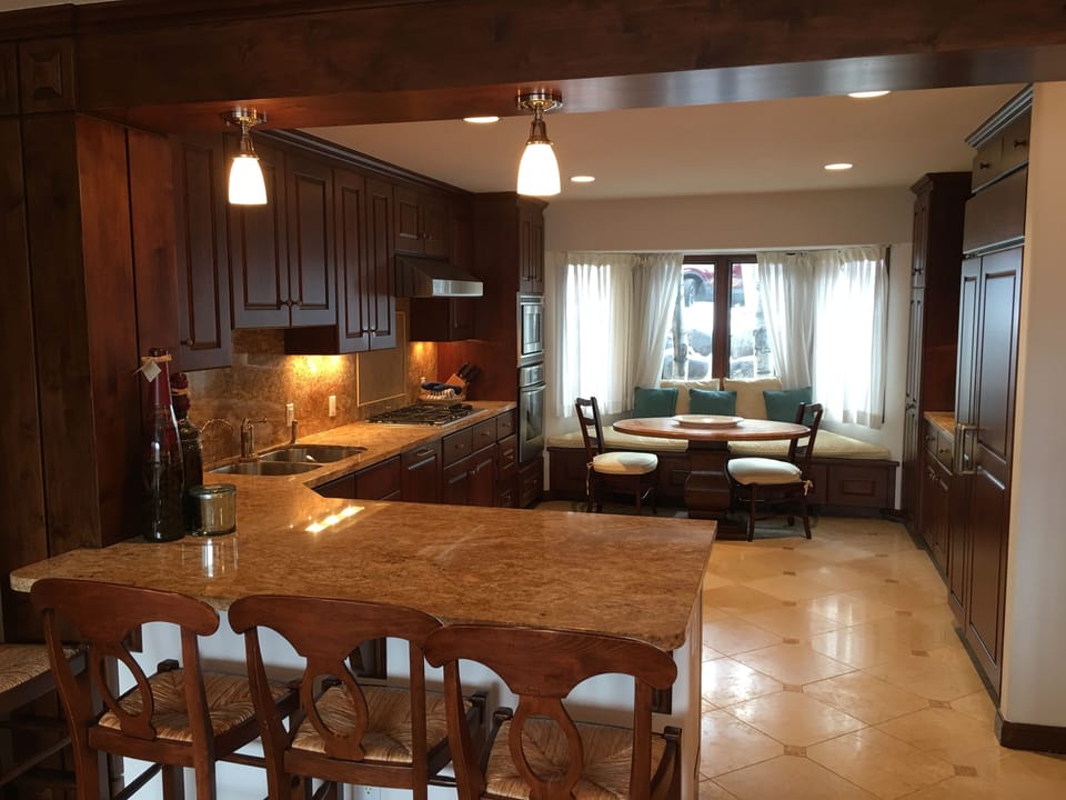 Kitchen with SubZero refrigerator, wine cooler, Thermador gas cooktop and oven. 