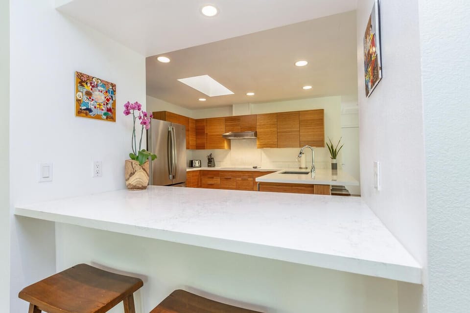 Prepare island-inspired meals together while guests gather at the breakfast bar for conversation.