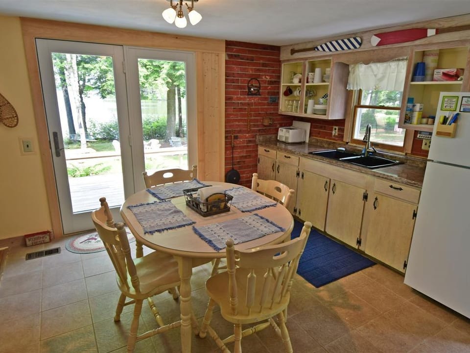 The eat in kitchen has easy access to the deck and the front door.