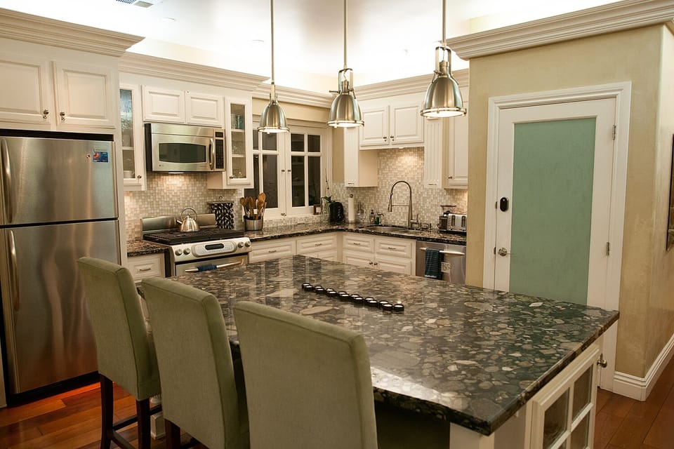 Left side of penthouses: open kitchen with bar stool seating, side door to BBQs