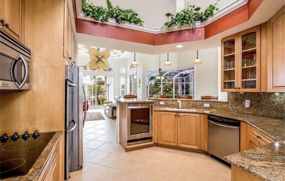 From kitchen, overlook patio, pool, and waterfront.