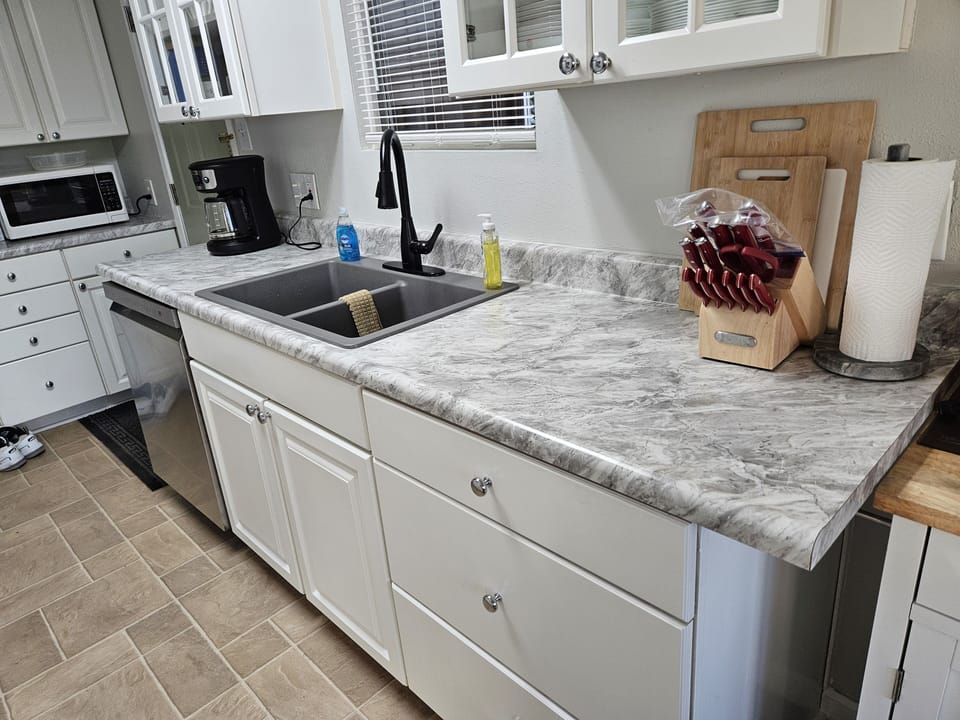 The other side of the kitchen counter with granite sink.