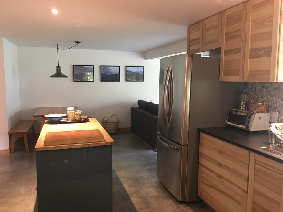 Full Kitchen with Full size Fridge, island, and gas range.