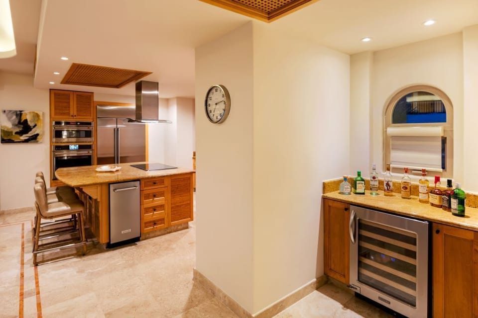 Kitchen and FULLY STOCKED Bar with wine and beverage cooler