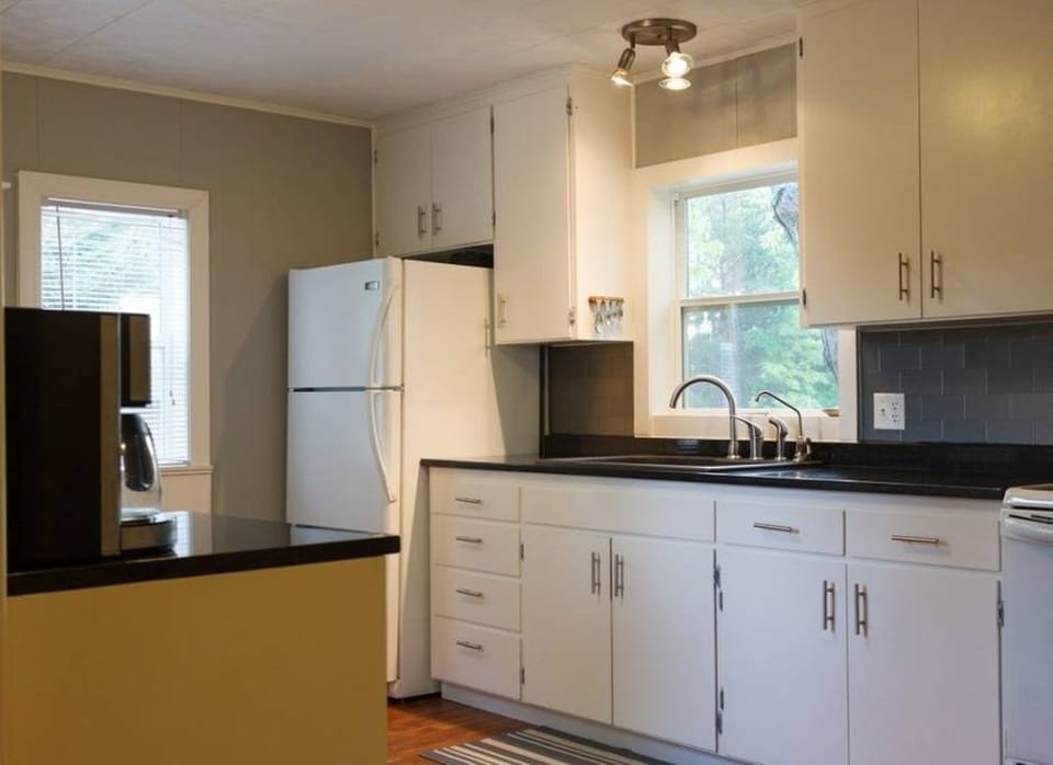 Fully equipped kitchen with refrigerator/freezer, stove, dishwasher, coffee pot