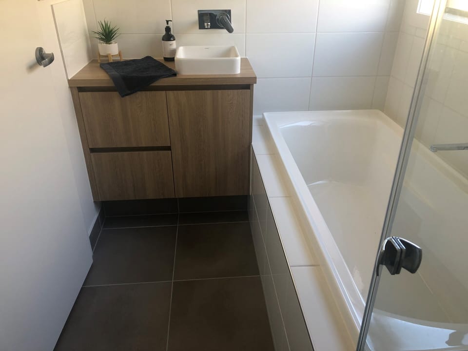 Modern main bathroom including bath, over sized shower and toilet