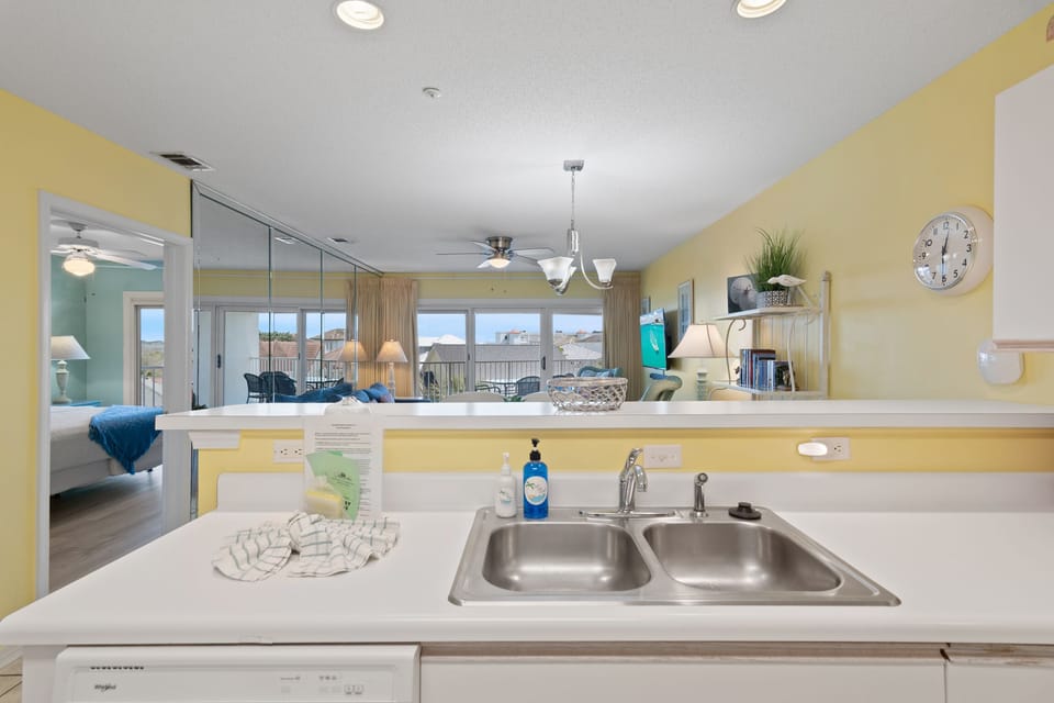 A bright kitchen with a pass-through to the living space.