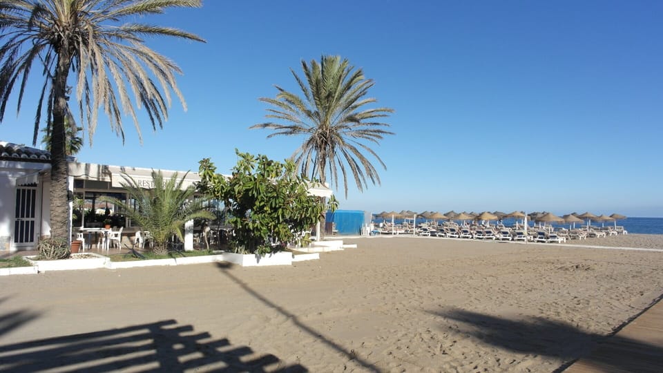 Beach in front of the building.