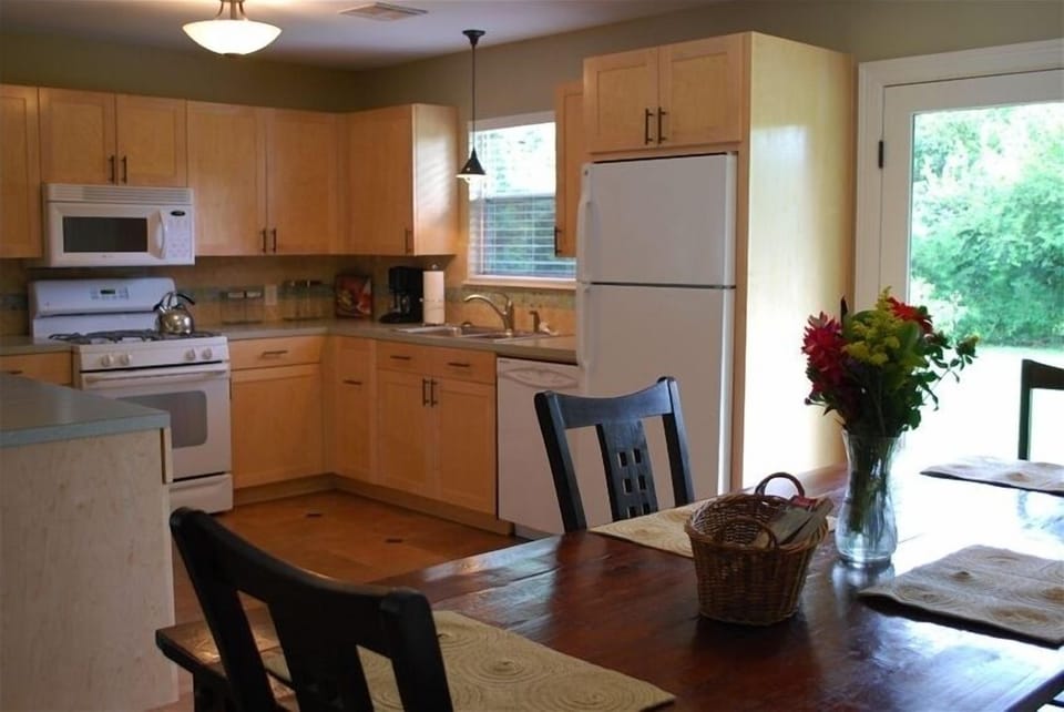 Architect designed, fully equipped kitchen invites dining and cooking in.