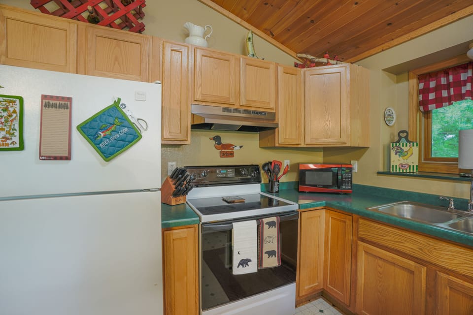 Stove, microwave, wooded view over kitchen sink... 