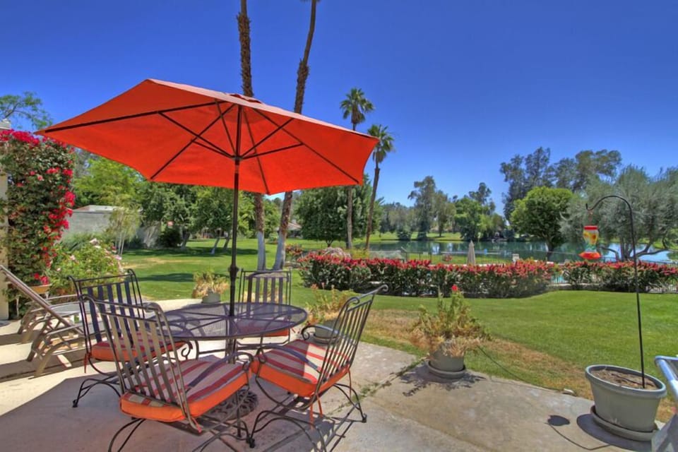 The back patio overlooks the pool, lake with waterfall and No. 6 of the Course