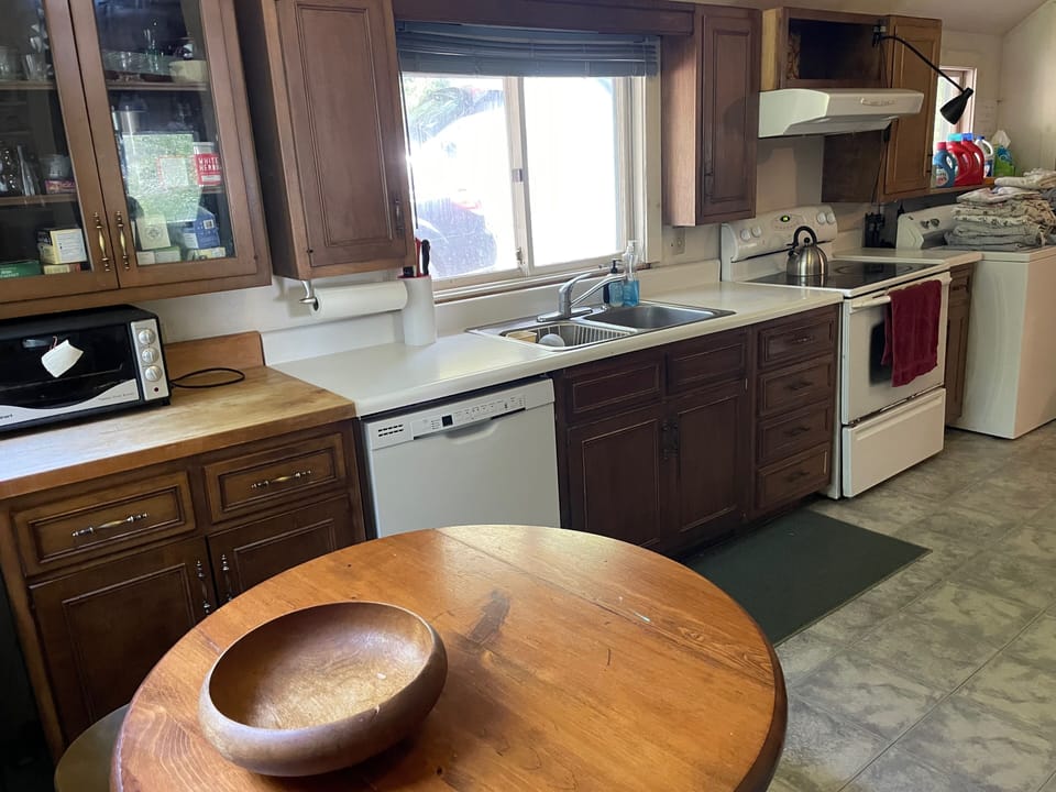The kitchen also has a washer and dryer (on the far right)