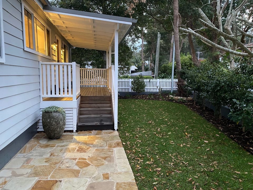 "Stone and wood" feature in the fully fenced front yard. A landscaped oasis!