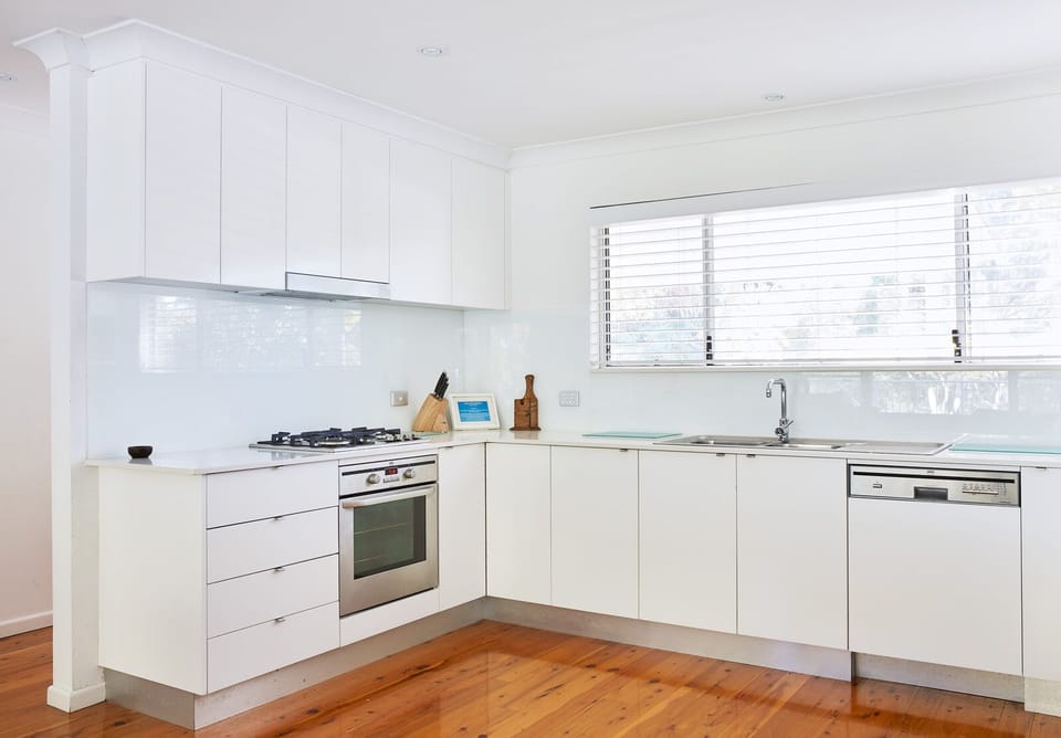 Fully equipped gourmet kitchen with stainless steel appliances and dishwasher.